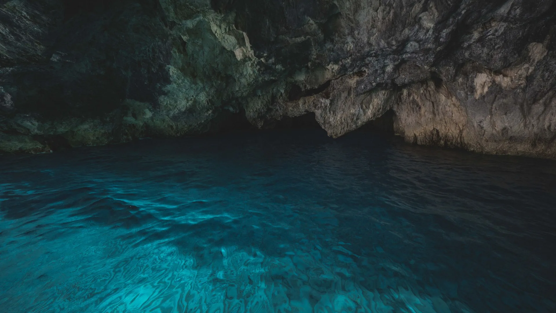 The glowing electric-blue water inside the Blue Grotto sea cave of Capri